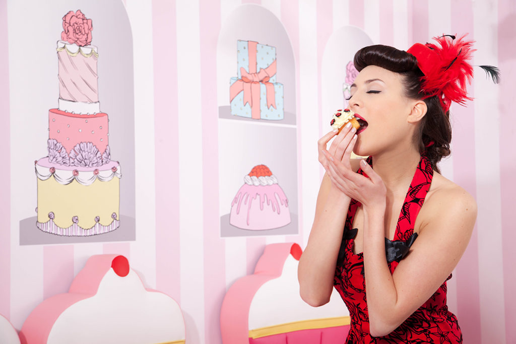 Morgabe Enselme dressed pinup sipping a cupcake - suspender-my-addiction