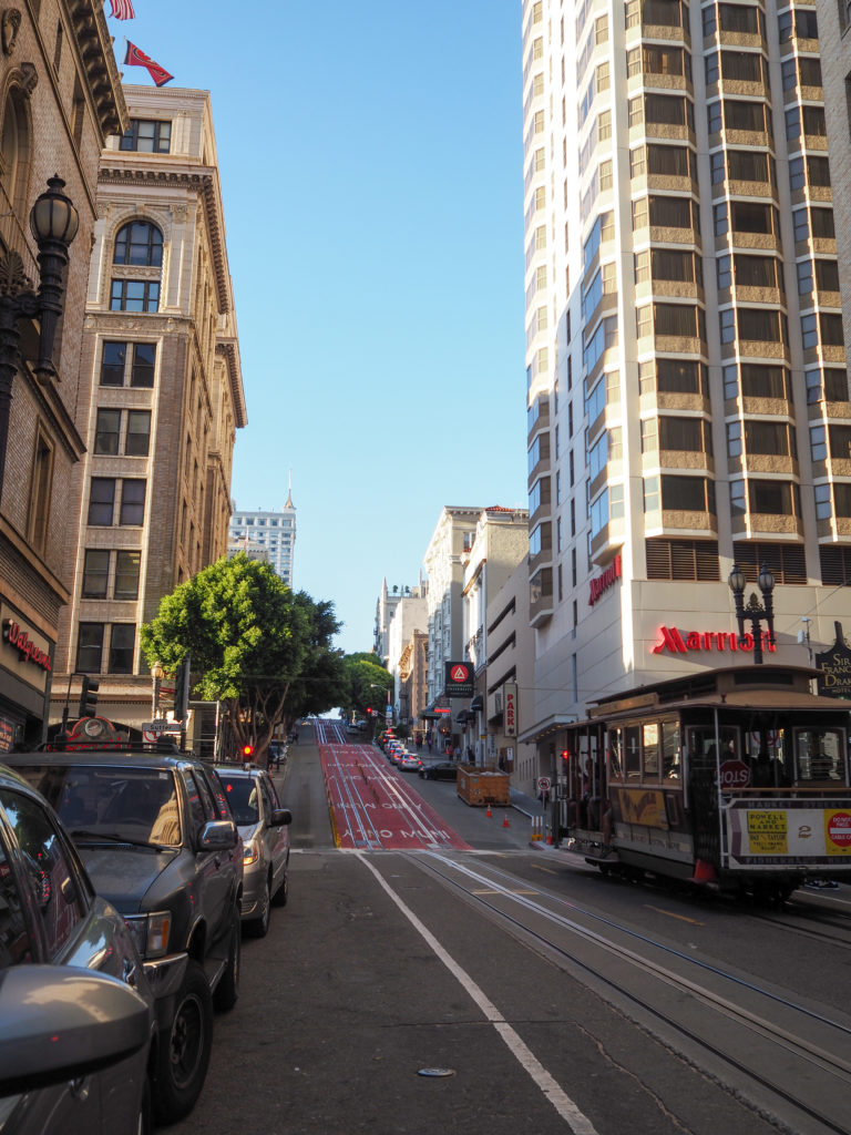 Rising street in san francisco and cable car